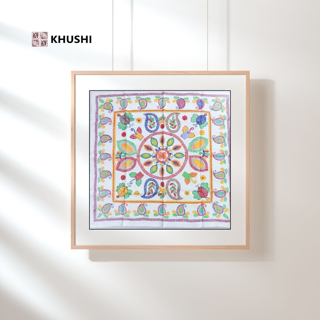 Colorful patterned fabric in a wooden frame with 'KHUSHI' branding on a white background
