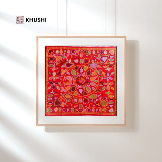 Framed artwork with a red and pink abstract design on a white wall, featuring the brand 'KHUSHI'.
